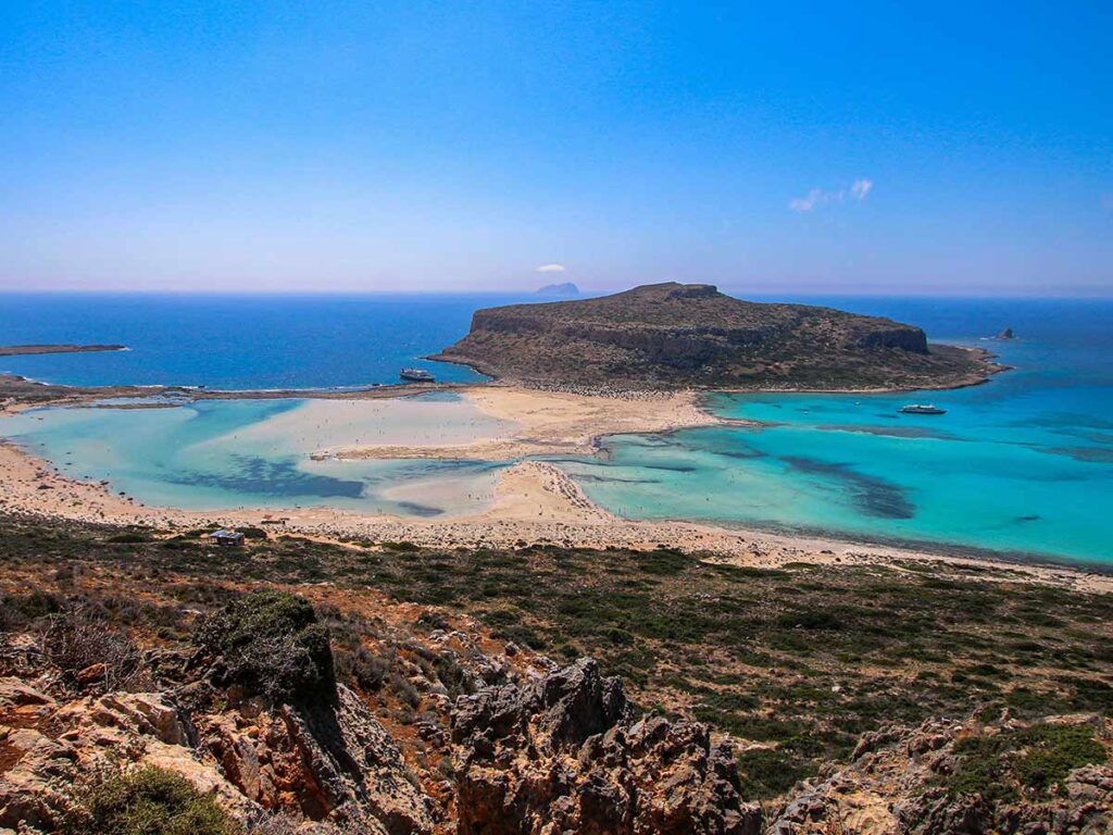<strong>Crete temperature by month: What to expect all year round</strong> 6 Aerial view of Balos Lagoon in Crete with turquoise waters, sandy paths, and the island of Gramvousa in the distance — a natural paradise.