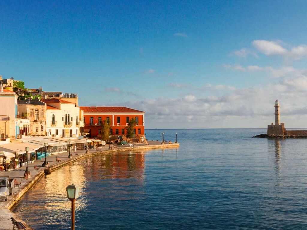 <strong>Crete temperature by month: What to expect all year round</strong> 1 Sunset view of the Chania old harbor with colorful Venetian buildings, seaside cafés, and the historic lighthouse in Crete, Greece.